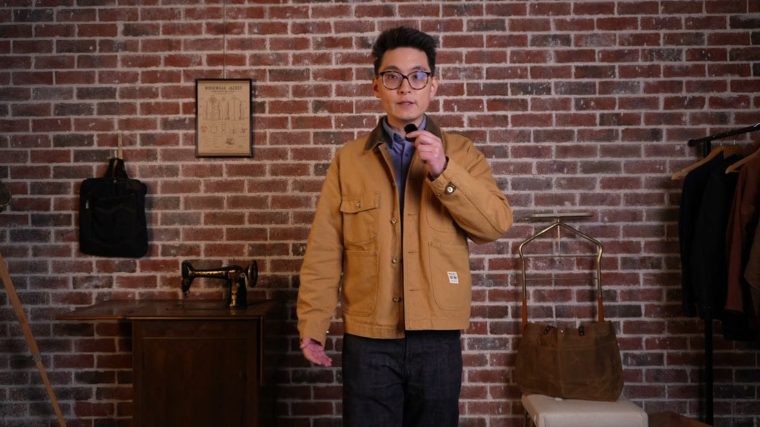 Mark wearing the golden-tan Maden Canvas Chore Coat in front of a brick wall.