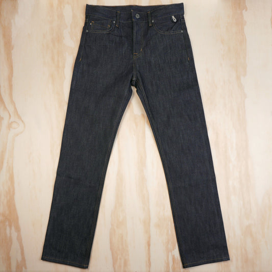 Dark indigo straight-fit selvedge jeans laid flat, front view.