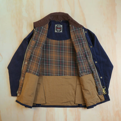 Navy corduroy hunting jacket opened to show the checked cotton lining and tan lower interior.