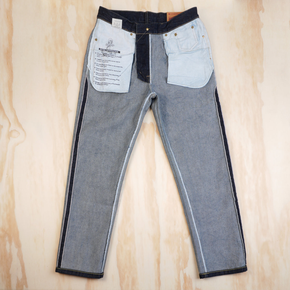 Inside front of OKONKWO jeans showing pocket bags and fly construction
