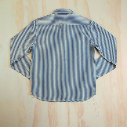 Back of the hickory stripe cotton work shirt, showing the horizontal striped yoke and curved hem.