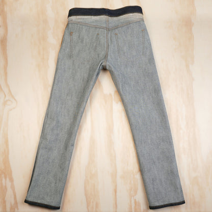 Inside-back view of the jeans showing the reverse of the denim and enclosed seams.