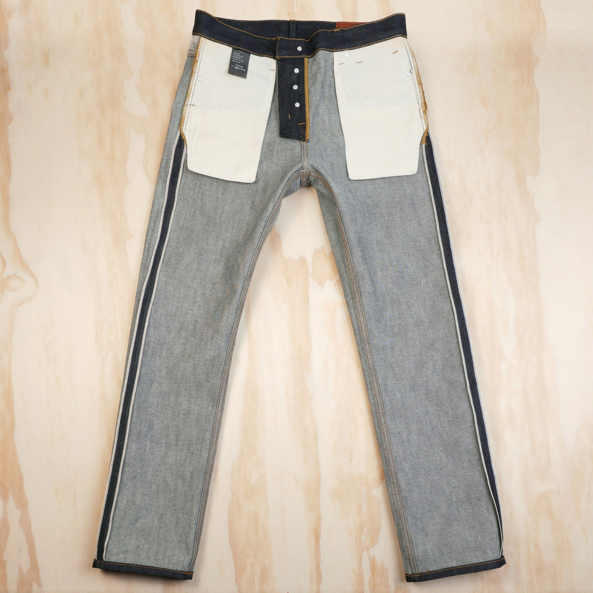 Inside-front view of the jeans showing cotton pocket bags and enclosed seams.